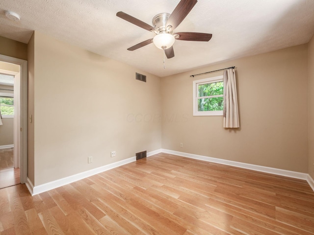 4656 Crompton Dr, Columbus, OH 43220 - empty room with a smoke detector, plenty of natural light, light wood-style flooring, and a ceiling fan