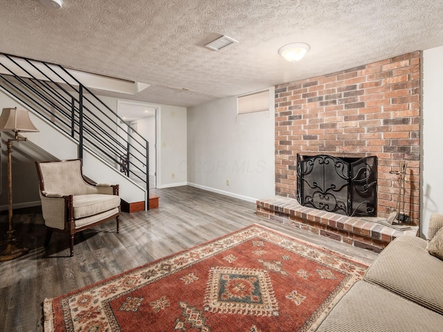 4656 Crompton Dr, Columbus, OH 43220 - living room with wood finished floors, a textured ceiling, a fireplace, and stairs