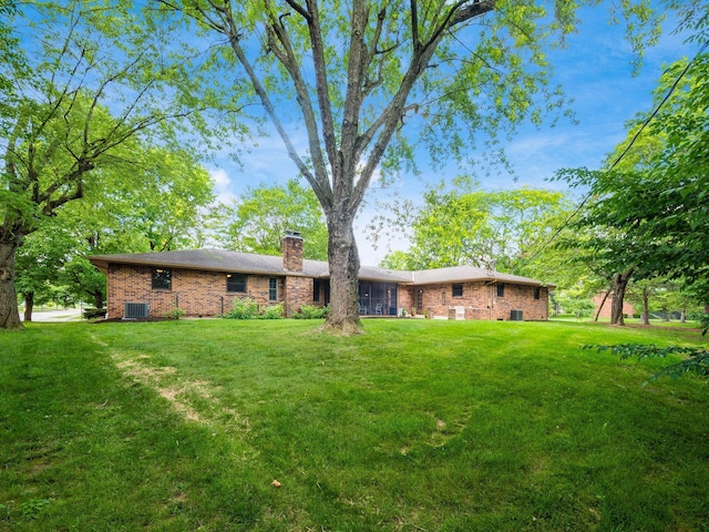 4656 Crompton Dr, Columbus, OH 43220 - back of house with a chimney, brick siding, and a yard