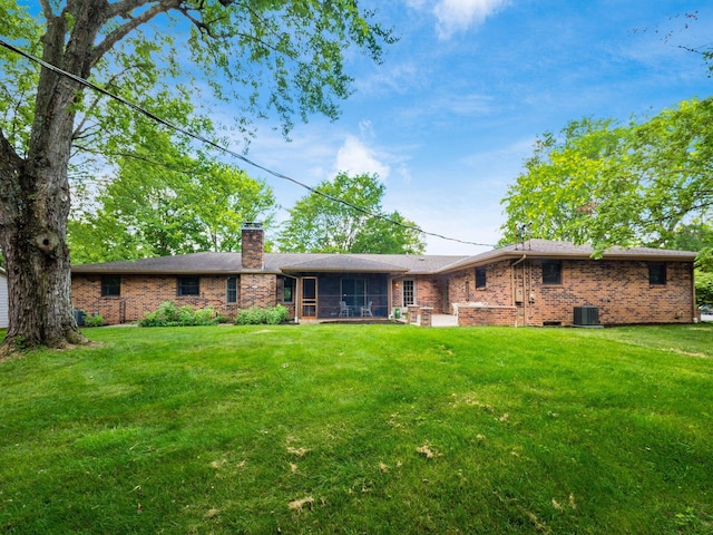 4656 Crompton Dr, Columbus, OH 43220 - back of property featuring a sunroom, brick siding, a lawn, and a chimney