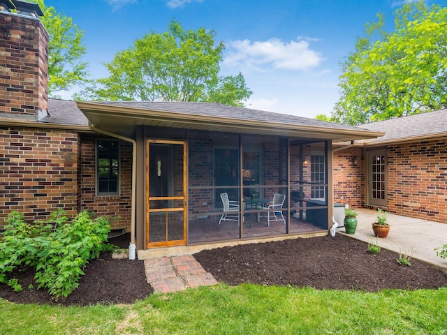 4656 Crompton Dr, Columbus, OH 43220 - property entrance with brick siding, a patio, a chimney, and roof with shingles
