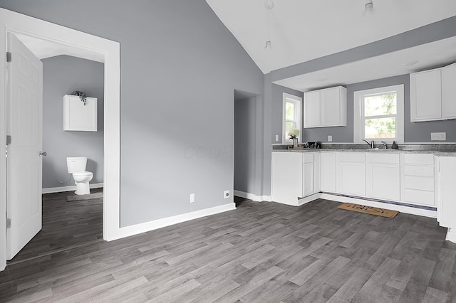 540 Park St, Marion, OH 43302 - kitchen featuring white cabinetry, wood finished floors, stone countertops, and high vaulted ceiling