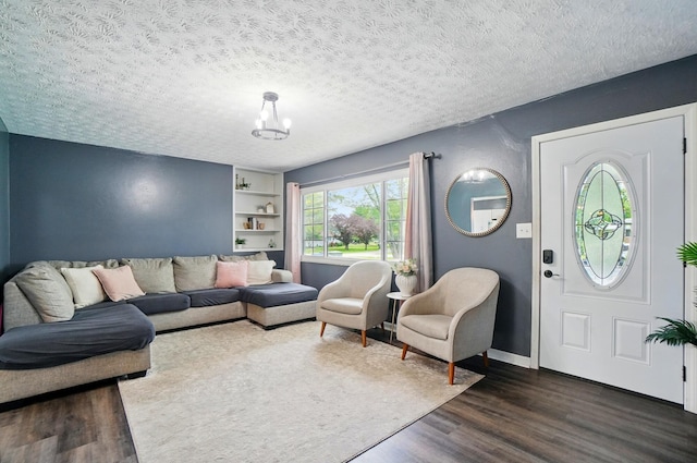 3722 Florian Dr, Columbus, OH 43219 - living area with dark wood-type flooring, a chandelier, a textured ceiling, and built in shelves