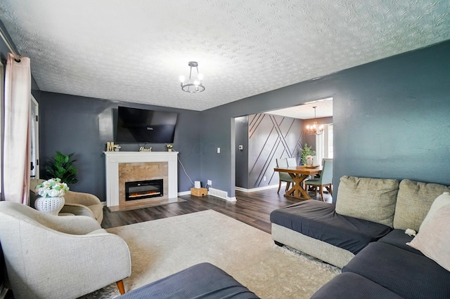 3722 Florian Dr, Columbus, OH 43219 - living area featuring a chandelier, wood finished floors, a glass covered fireplace, and a textured ceiling