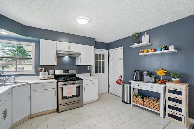 3722 Florian Dr, Columbus, OH 43219 - kitchen featuring gas stove, under cabinet range hood, light countertops, white cabinetry, and a textured ceiling