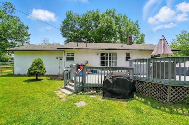 3722 Florian Dr, Columbus, OH 43219 - rear view of house with stucco siding, a yard, a deck, a chimney, and roof with shingles