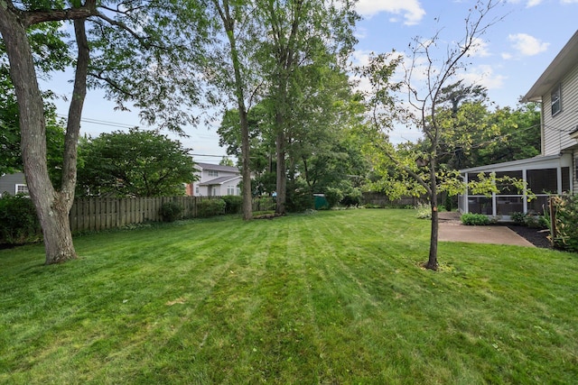 1295 Castleton Rd N, Columbus, OH 43220 - fenced backyard featuring a sunroom and a patio