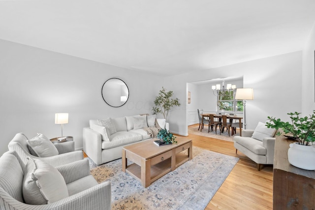 1295 Castleton Rd N, Columbus, OH 43220 - living room with light wood-style floors and a chandelier
