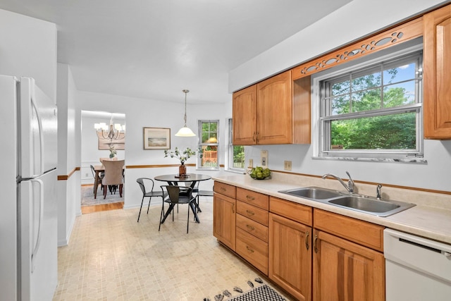 1295 Castleton Rd N, Columbus, OH 43220 - kitchen with white appliances, light countertops, plenty of natural light, and pendant lighting