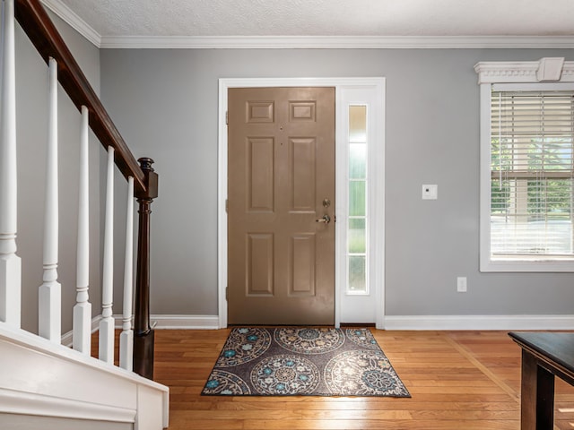 304 Cottage Grove Cir, Pataskala, OH 43062 - entrance foyer featuring light wood finished floors, stairway, and crown molding