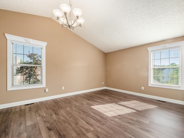 304 Cottage Grove Cir, Pataskala, OH 43062 - spare room with lofted ceiling, wood finished floors, a chandelier, and a textured ceiling