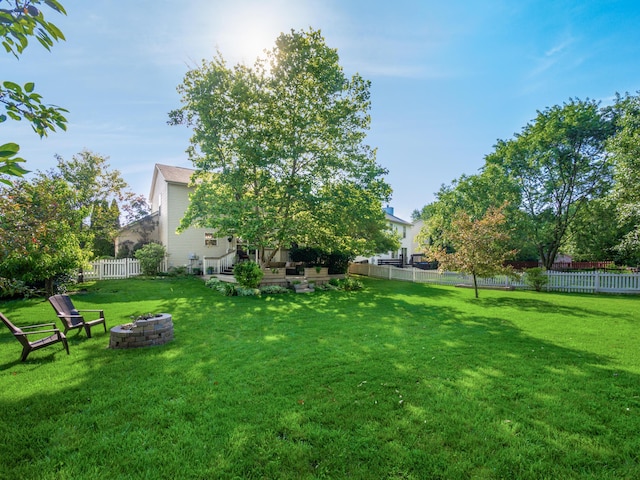 304 Cottage Grove Cir, Pataskala, OH 43062 - fenced backyard featuring a fire pit and a patio area