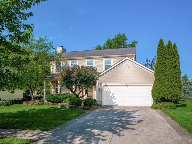 304 Cottage Grove Cir, Pataskala, OH 43062 - view of front of property with concrete driveway, a front lawn, a chimney, and an attached garage