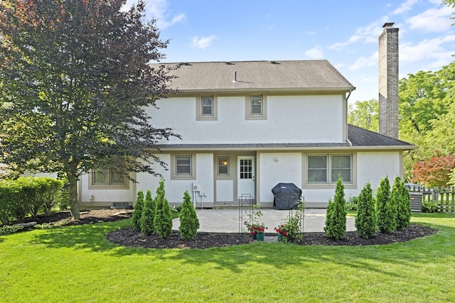 1292 Churchbell Way, Columbus, OH 43235 - back of house with a chimney, stucco siding, a patio, a lawn, and roof with shingles