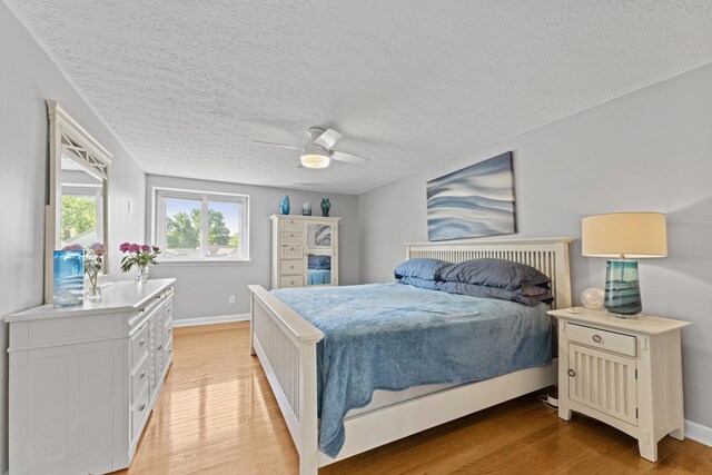 1292 Churchbell Way, Columbus, OH 43235 - bedroom with light wood finished floors, ceiling fan, and a textured ceiling