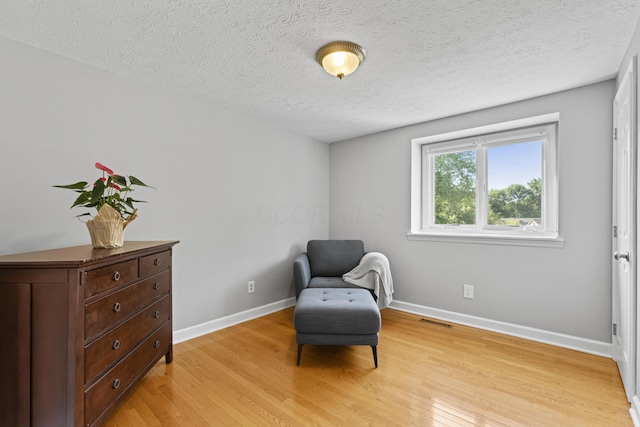 1292 Churchbell Way, Columbus, OH 43235 - living area featuring light wood-style flooring and a textured ceiling