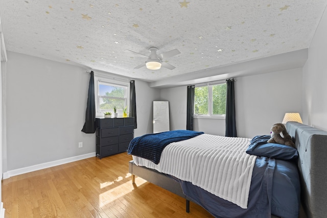1292 Churchbell Way, Columbus, OH 43235 - bedroom featuring light wood-style floors, multiple windows, and a ceiling fan