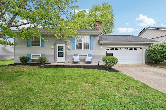 1853 Shasta Dr, Lancaster, OH 43130 - bi-level home featuring a garage, concrete driveway, a chimney, a front yard, and roof with shingles