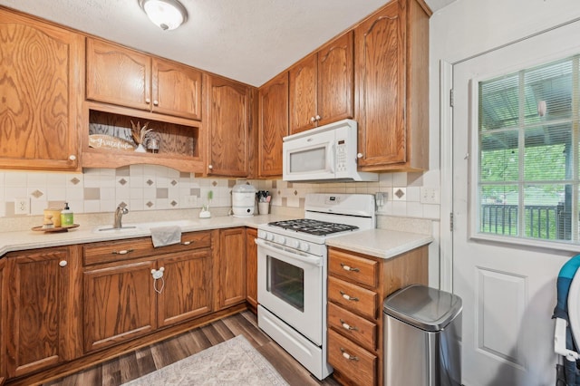 1853 Shasta Dr, Lancaster, OH 43130 - kitchen featuring white appliances, decorative backsplash, light countertops, dark wood-type flooring, and brown cabinets