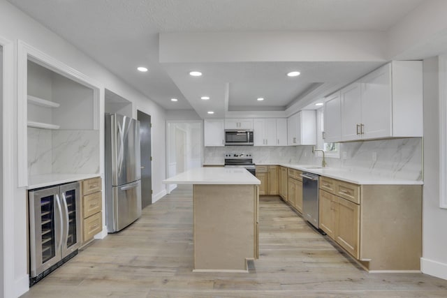 5200 Colt Ct, Westerville, OH 43081 - kitchen with appliances with stainless steel finishes, wine cooler, light wood-style floors, decorative backsplash, and a center island
