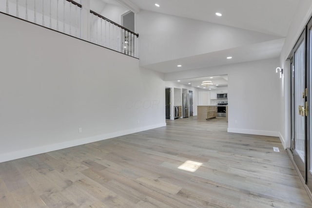5200 Colt Ct, Westerville, OH 43081 - unfurnished living room featuring high vaulted ceiling, recessed lighting, and light wood-style flooring