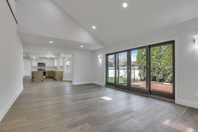 5200 Colt Ct, Westerville, OH 43081 - unfurnished living room featuring healthy amount of natural light, light wood finished floors, recessed lighting, and high vaulted ceiling