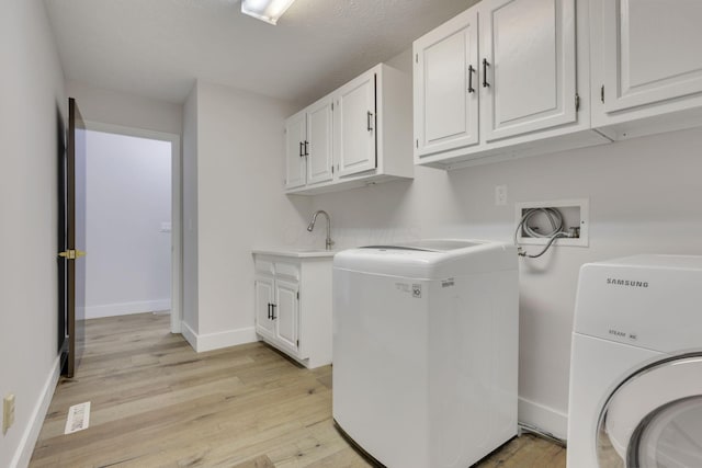5200 Colt Ct, Westerville, OH 43081 - laundry area with washer hookup, light wood finished floors, and cabinet space
