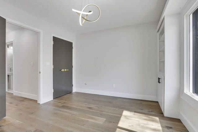 5200 Colt Ct, Westerville, OH 43081 - empty room with light wood finished floors and a chandelier