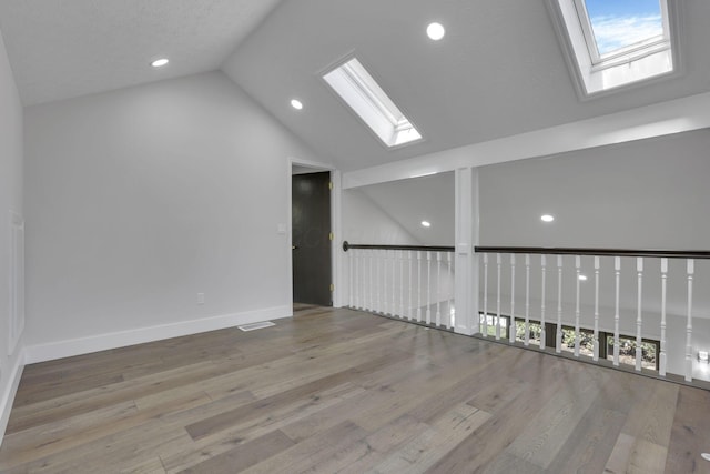 5200 Colt Ct, Westerville, OH 43081 - spare room featuring a skylight, vaulted ceiling, wood finished floors, and recessed lighting
