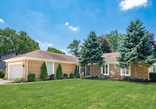 2247 Sonnington Dr, Dublin, OH 43016 - ranch-style home with brick siding, a front yard, an attached garage, driveway, and roof with shingles