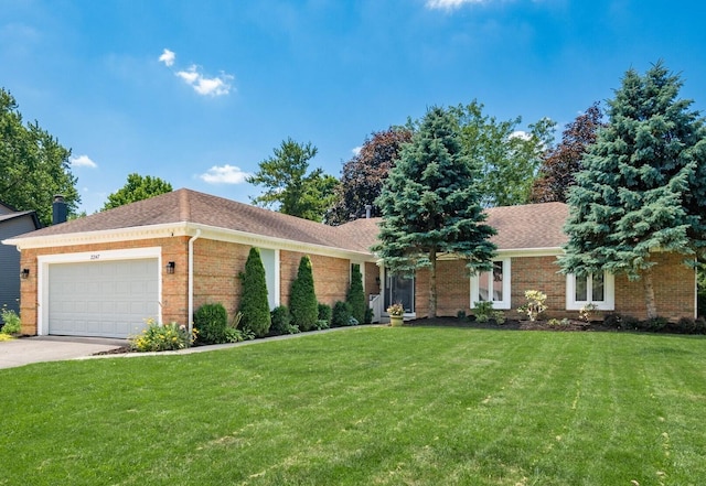 2247 Sonnington Dr, Dublin, OH 43016 - ranch-style home featuring brick siding, a garage, a front lawn, concrete driveway, and roof with shingles
