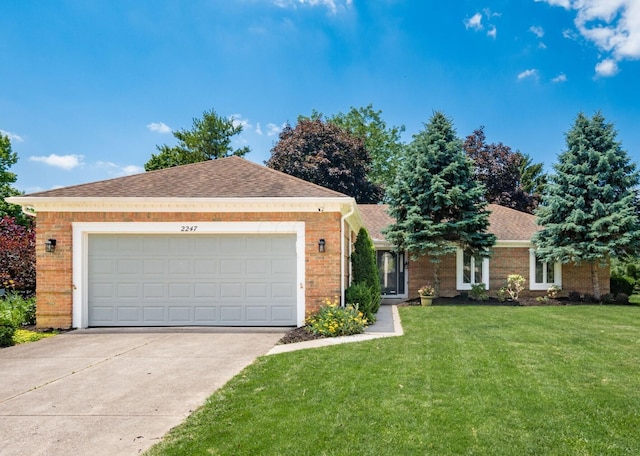 2247 Sonnington Dr, Dublin, OH 43016 - single story home featuring driveway, a front yard, brick siding, an attached garage, and roof with shingles