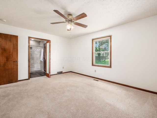 2247 Sonnington Dr, Dublin, OH 43016 - unfurnished bedroom featuring light colored carpet, a textured ceiling, ceiling fan, and ensuite bathroom