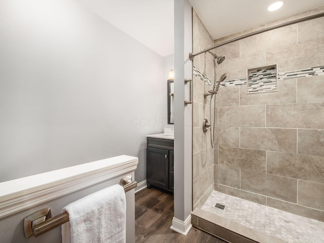 2247 Sonnington Dr, Dublin, OH 43016 - bathroom featuring vanity, tiled shower, wood finished floors, and recessed lighting