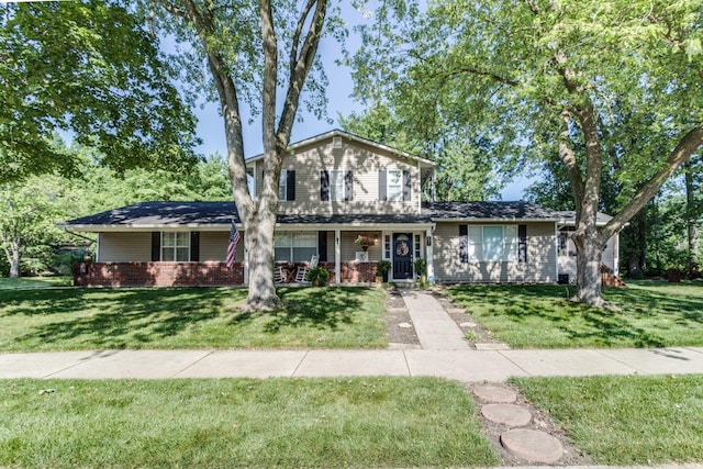 691 Heritage Blvd, Delaware, OH 43015 - traditional home with a front lawn, brick siding, and a porch
