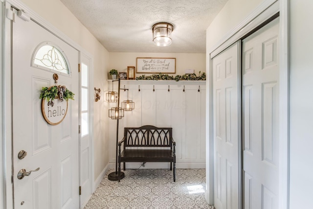 691 Heritage Blvd, Delaware, OH 43015 - mudroom featuring a textured ceiling and baseboards