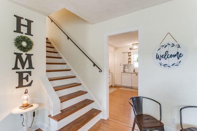 691 Heritage Blvd, Delaware, OH 43015 - staircase with a textured ceiling and wood finished floors