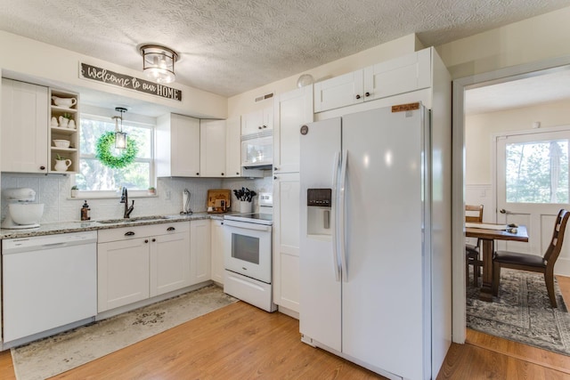 691 Heritage Blvd, Delaware, OH 43015 - kitchen featuring white appliances, light wood finished floors, white cabinetry, and a textured ceiling
