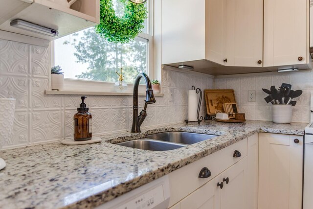 691 Heritage Blvd, Delaware, OH 43015 - kitchen with white cabinetry, tasteful backsplash, and light stone countertops