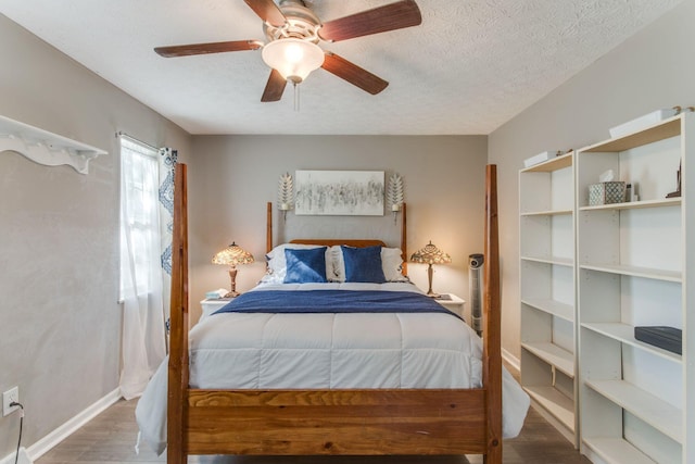 691 Heritage Blvd, Delaware, OH 43015 - bedroom with wood finished floors, a ceiling fan, and a textured ceiling