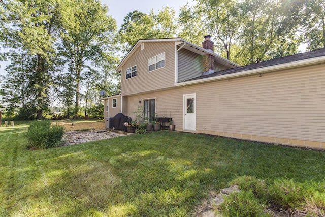 691 Heritage Blvd, Delaware, OH 43015 - rear view of house featuring a chimney and a yard