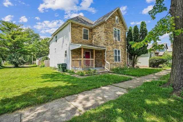 137 Wisconsin Ave, Columbus, OH 43222 - view of front of property with stone siding, a porch, and a front lawn