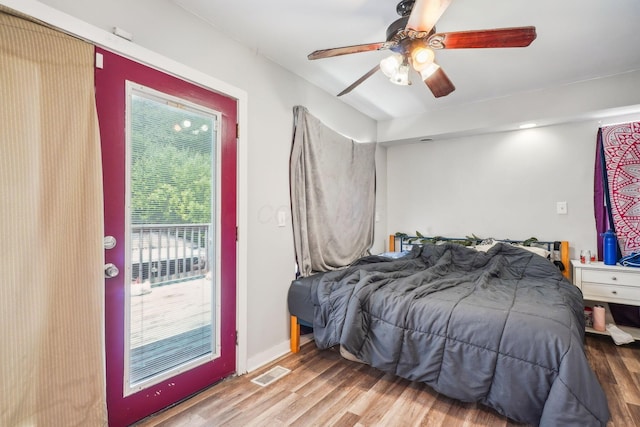 137 Wisconsin Ave, Columbus, OH 43222 - bedroom with wood finished floors, multiple windows, ceiling fan, and access to exterior
