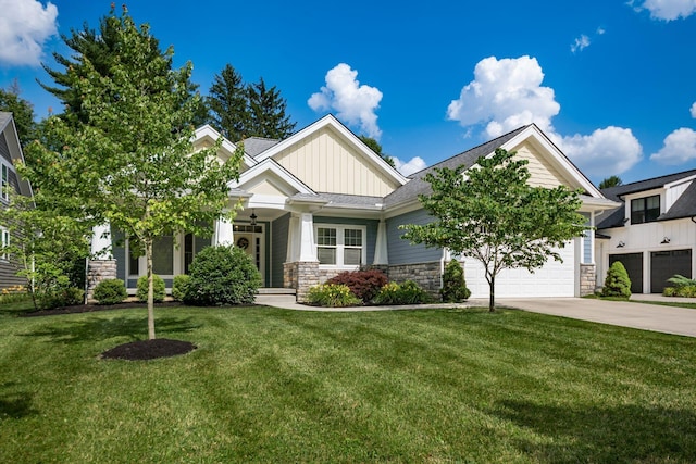 174 Grand Ridge Ct, Gahanna, OH 43230 - craftsman inspired home with board and batten siding, driveway, a garage, a front yard, and stone siding