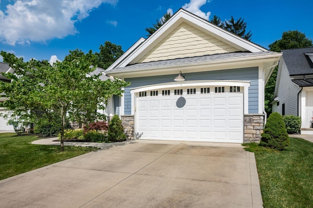 174 Grand Ridge Ct, Gahanna, OH 43230 - view of front of property with stone siding, a front lawn, concrete driveway, and a garage