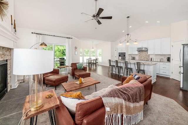 174 Grand Ridge Ct, Gahanna, OH 43230 - living room with a stone fireplace, high vaulted ceiling, dark wood-style floors, ceiling fan, and recessed lighting