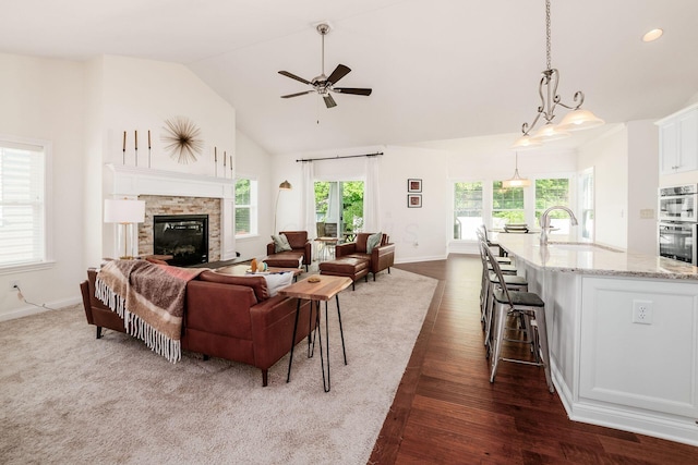 174 Grand Ridge Ct, Gahanna, OH 43230 - living area featuring dark wood-type flooring, ceiling fan, a fireplace, and high vaulted ceiling