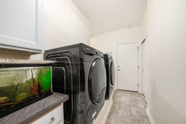 174 Grand Ridge Ct, Gahanna, OH 43230 - laundry room featuring independent washer and dryer, cabinet space, and light tile patterned flooring