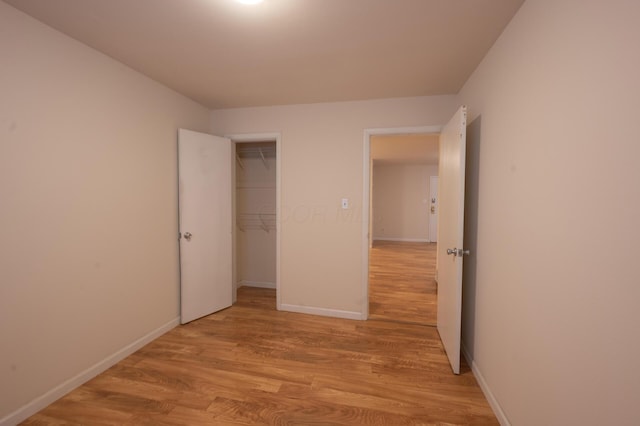 433 E 13th Ave, Columbus, OH 43201 - unfurnished bedroom with light wood-type flooring and a closet