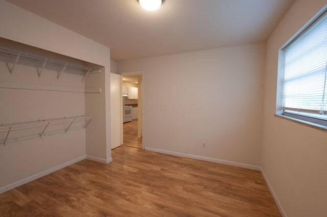 433 E 13th Ave, Columbus, OH 43201 - unfurnished bedroom featuring wood finished floors and baseboards